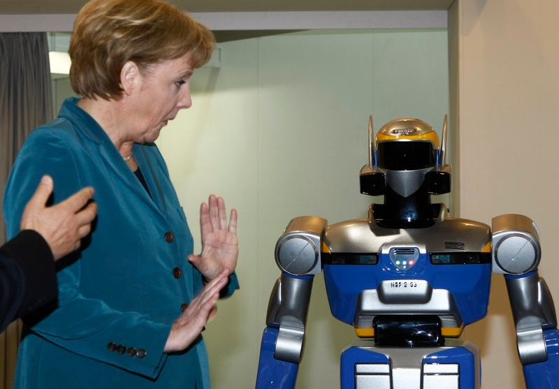 Illustration for article titled Why Is Angela Merkel Always Palling Around With Robots?